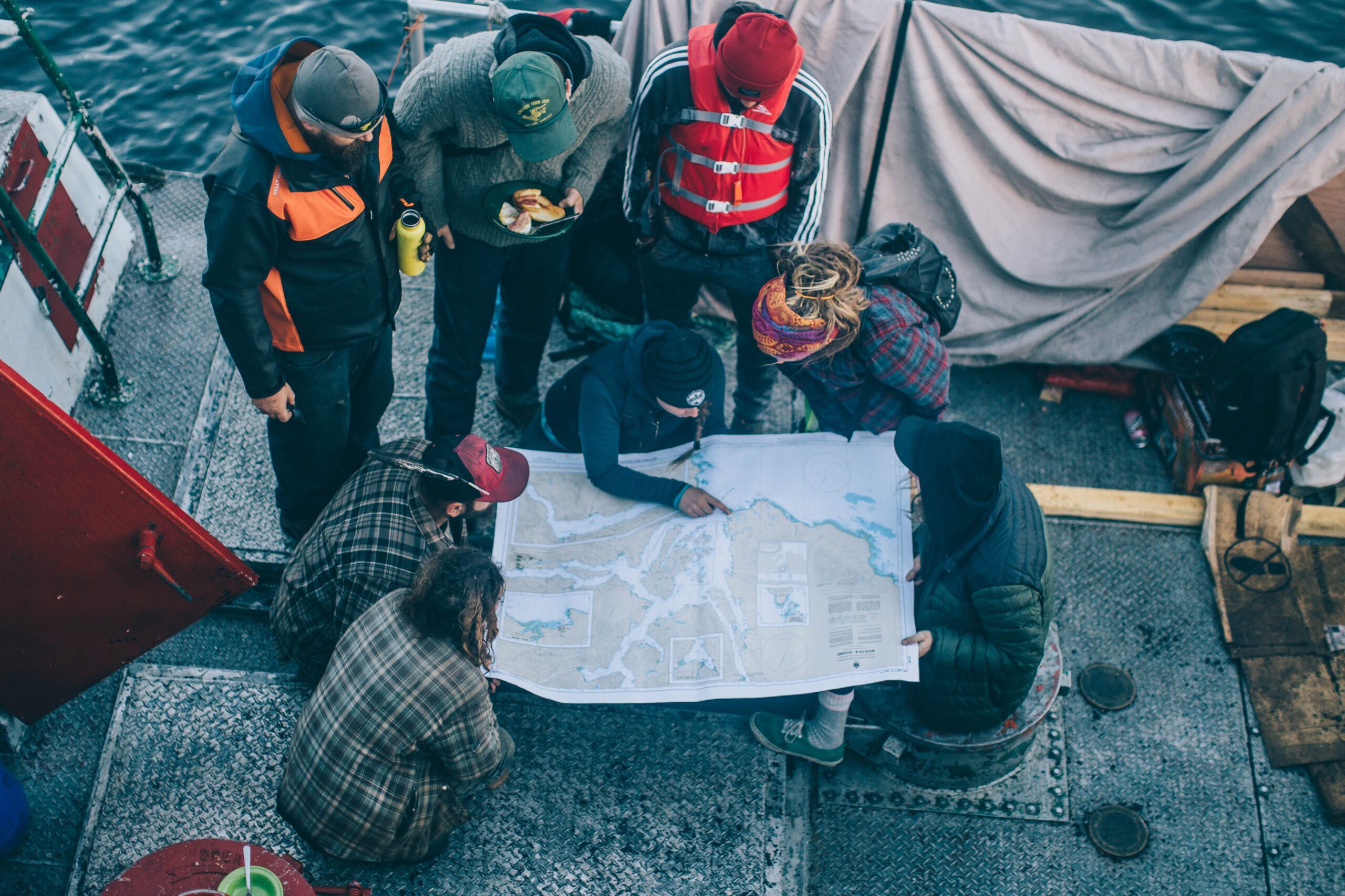 ocean legacy volunteers with map on a boat